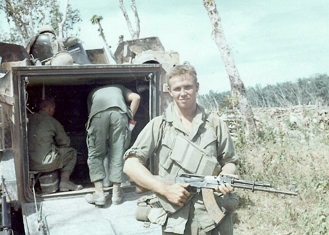 Jim Lally holding a captured wepon